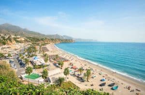 View of beach in Nerja. Malaga province, Costa del Sol, Andalusia, Spain, Burriana Beach during hot summer and sunny day.