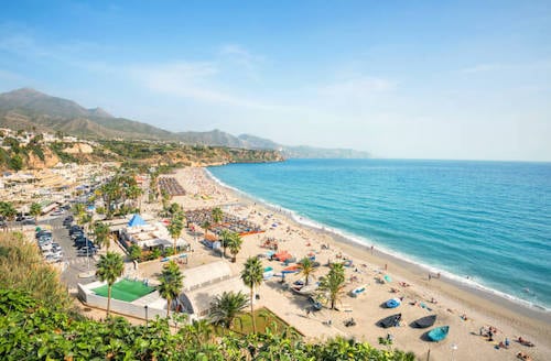 View of beach in Nerja. Malaga province, Costa del Sol, Andalusia, Spain, Burriana Beach during hot summer and sunny day.
