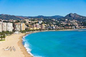 Beautiful view of the coastline of Malaga city, Andalusia, Spain with some residential buildings close to the beach during sunny day.