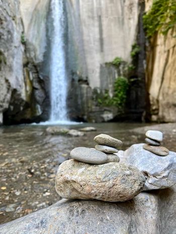 Waterfall and stones as one of multiple beautiful views you can have going on Granada hiking.