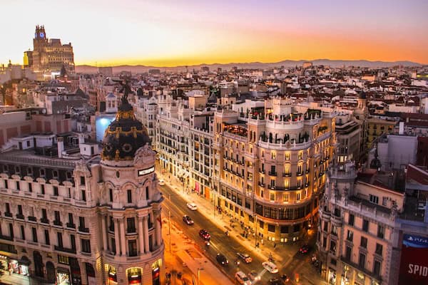 The view from the height on Madrid's city center, important buildings of Spain's capital during orange sunset.