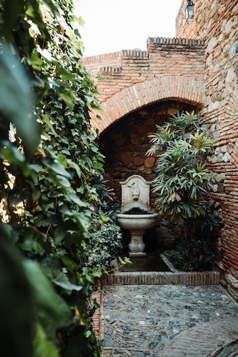 A rustic, historical fountain inside the Alcazaba fortress in Malaga