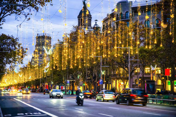 Christmas lights on Passeig de Gracia, cars in Barcelona at Christmas, new year decoration in the city.