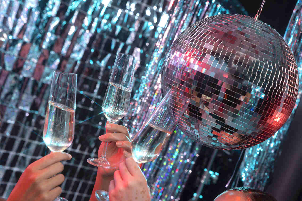 New Year's party at the club during New Year's Eve in Malaga 2024 - disco ball and champagne