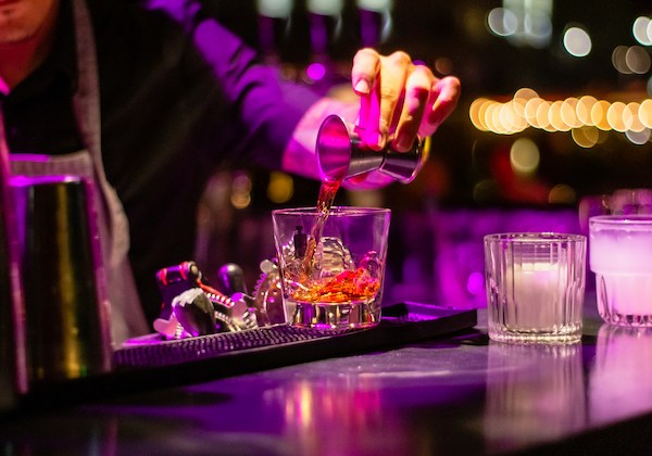 Bartender pouring spirits into a glass in New Year's Eve in Barcelona