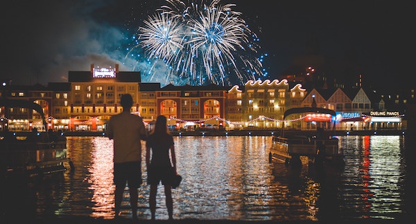 Couple watching new years eve fireworks by the water