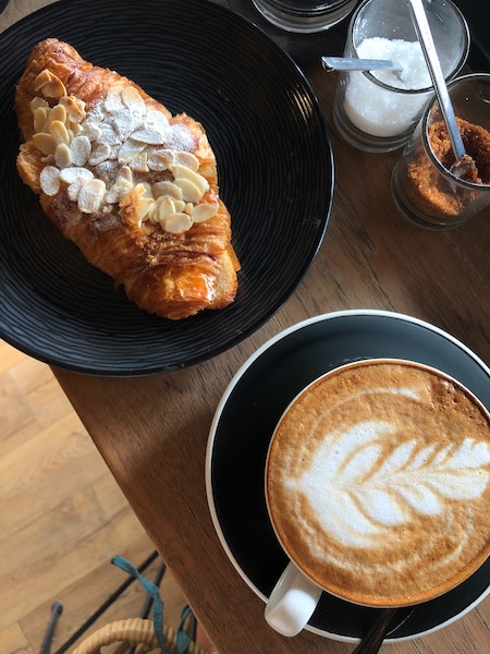 a picture of croissant and best coffee in barcelona 2024