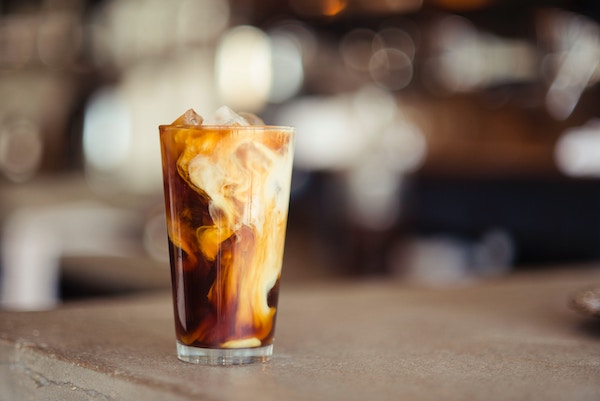 ice latte glass, milk fusing with coffee