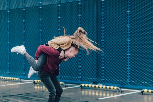 couple man carrying woman on his back