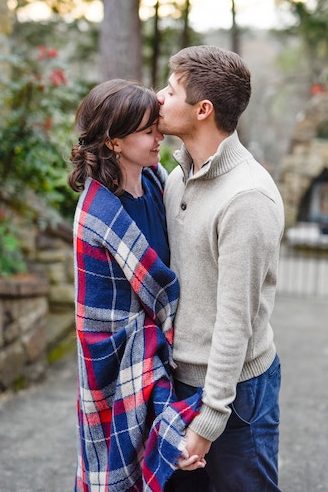 heterosexual couple holding hands kissing