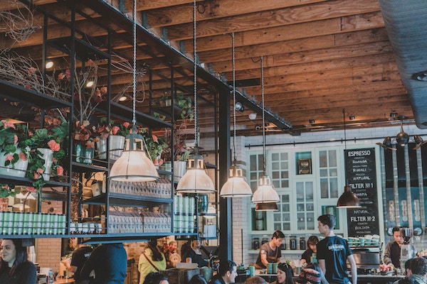 Cozy coffee shop with wooden ceiling and hanging lamps