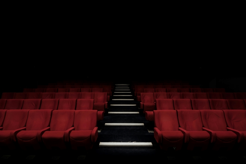 Several empty chairs in a film theatre.