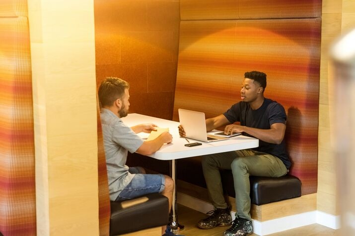 Two people coworking on their laptops in a coworking space