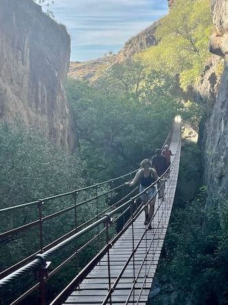 Granada Hiking with some people on bridge in the mountains of Sierra Nevada, Andalusia, Spain during sunny and warm day.