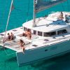 Malaga Boat Trip; Some people laying and relaxing at the white catamaran floating on the sea in Malaga, Spain during sunny summer day.
